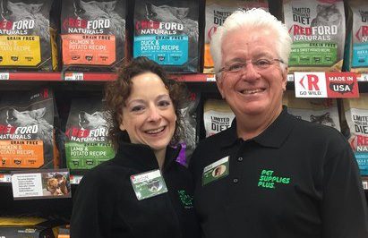 a father and daughter franchise pair are standing in the aisle of the store