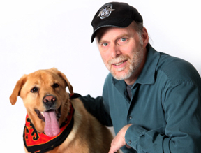 Franchise Owner kneeling with his golden retriever dog