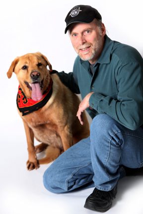 Franchise Owner kneeling with his golden retriever dog