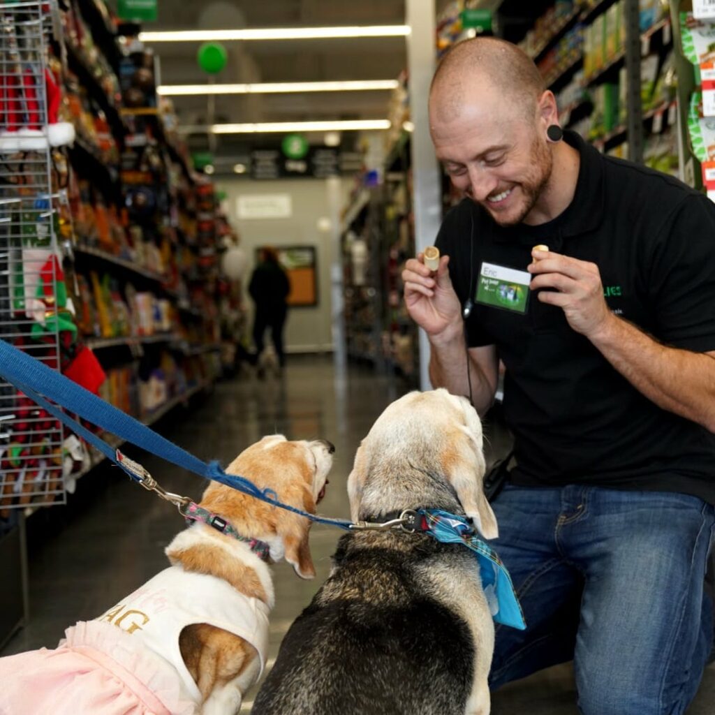 Pet Supplies Plus employee with 2 dogs